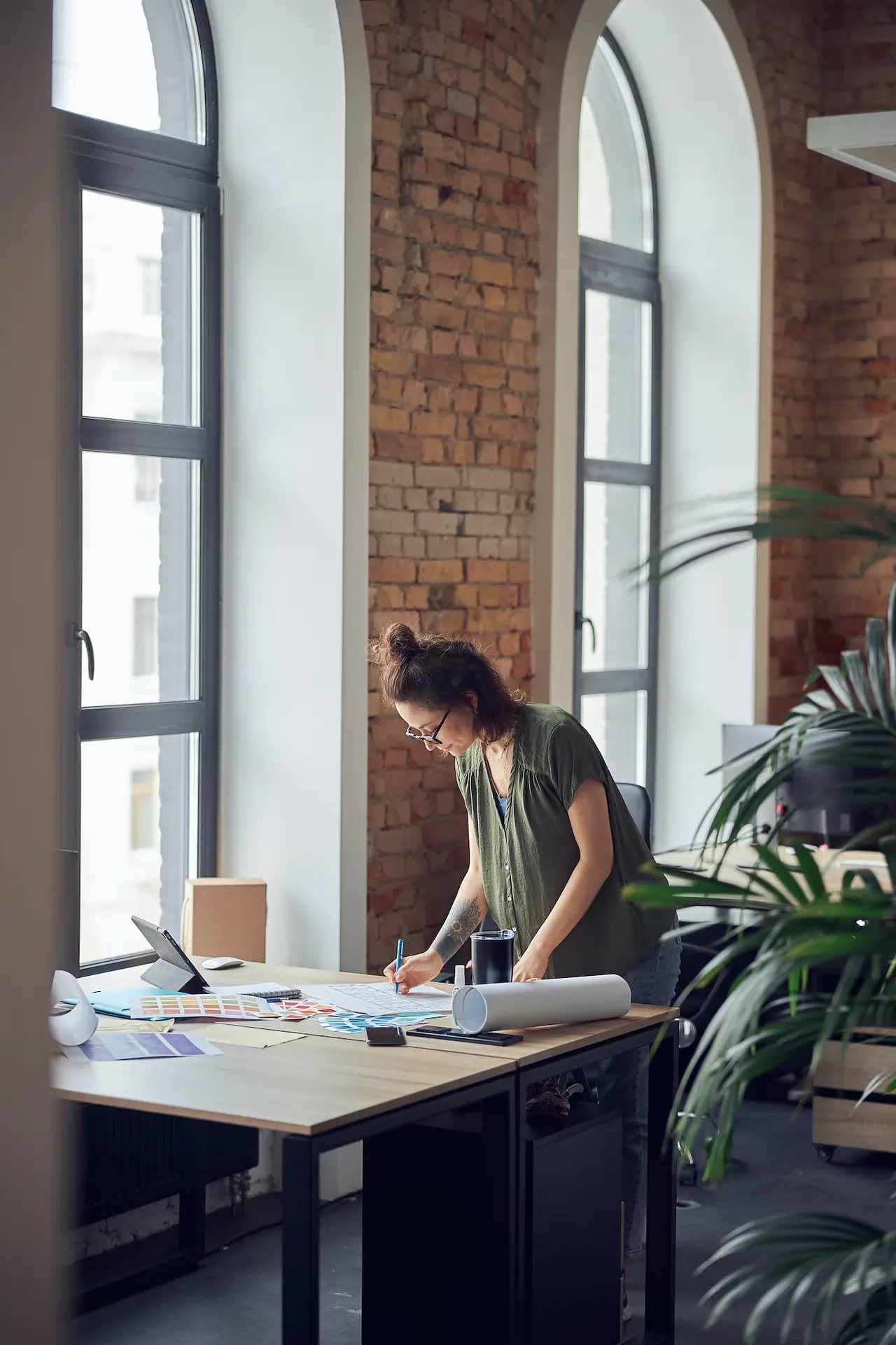 interior-designer-or-architect-in-casual-wear-with-messy-hairdo-looking-focused-while-working-on.jpg