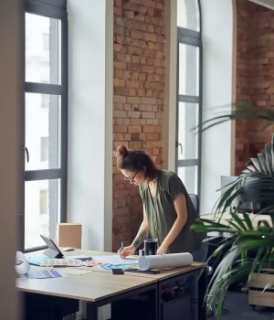 interior-designer-or-architect-in-casual-wear-with-messy-hairdo-looking-focused-while-working-on.jpg